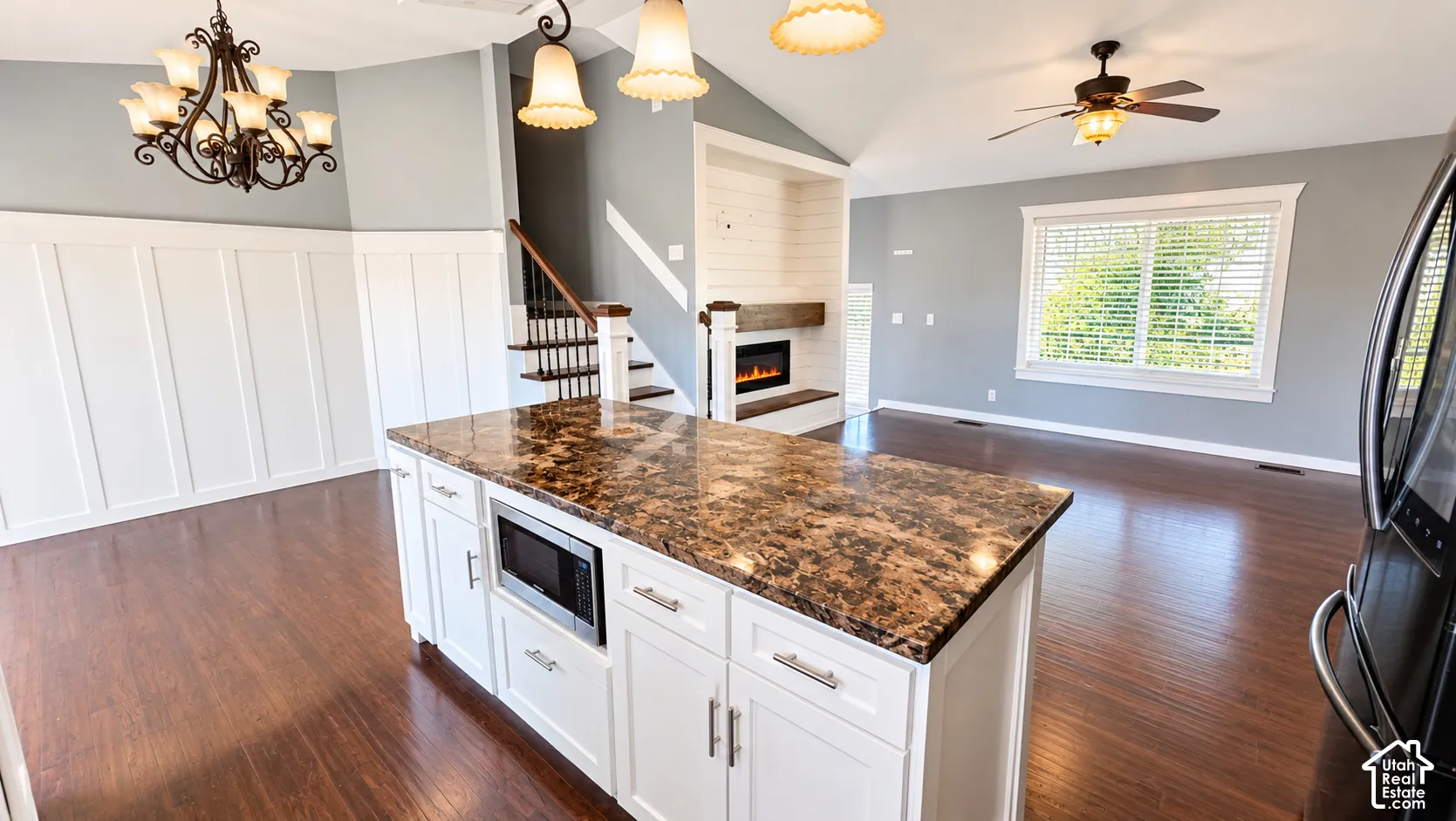 Kitchen island with built-in microwave and stone-finish countertop