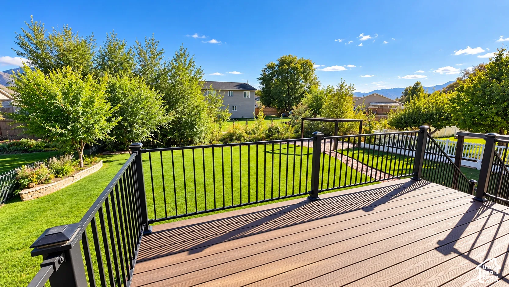 Composite wood-finish decking with black metal railings