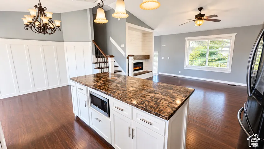 Kitchen island with built-in microwave and stone-finish countertop