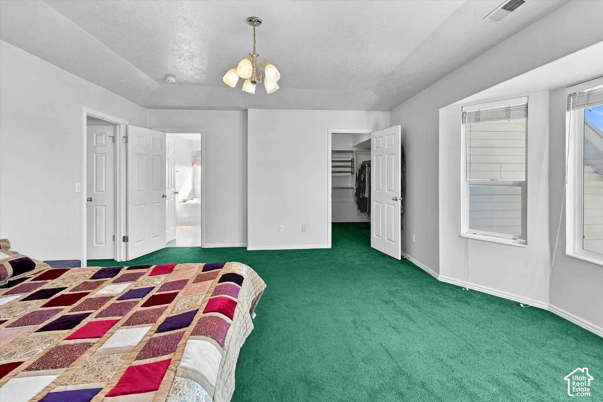 Primary suite leading to oversized walk-in closet and en-suite.