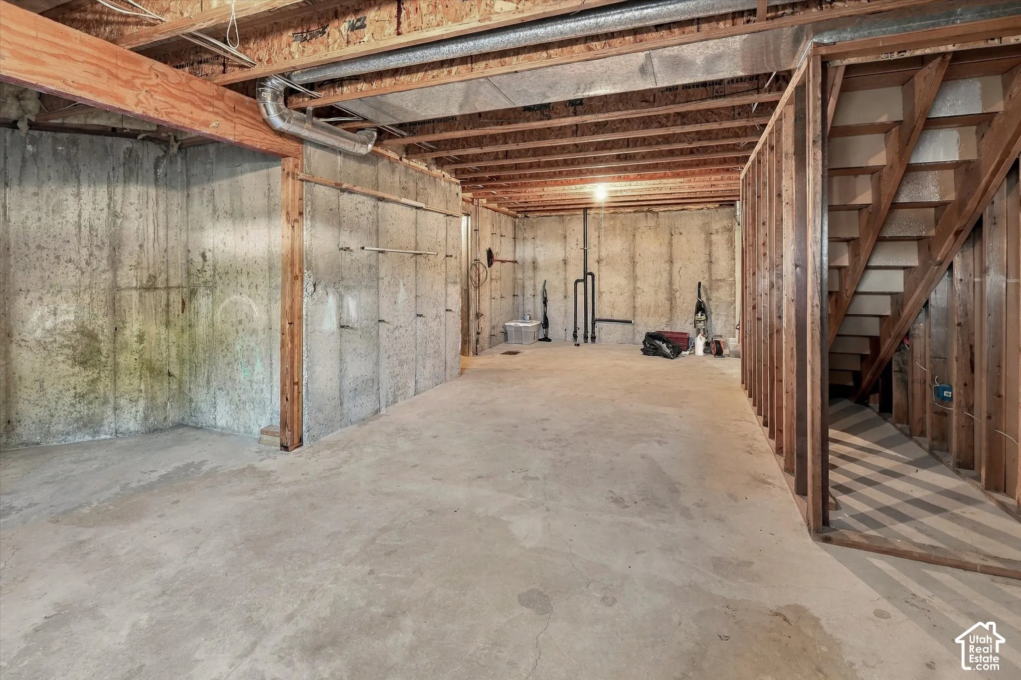 Concrete flooring with exposed ceiling joists and wood beam construction