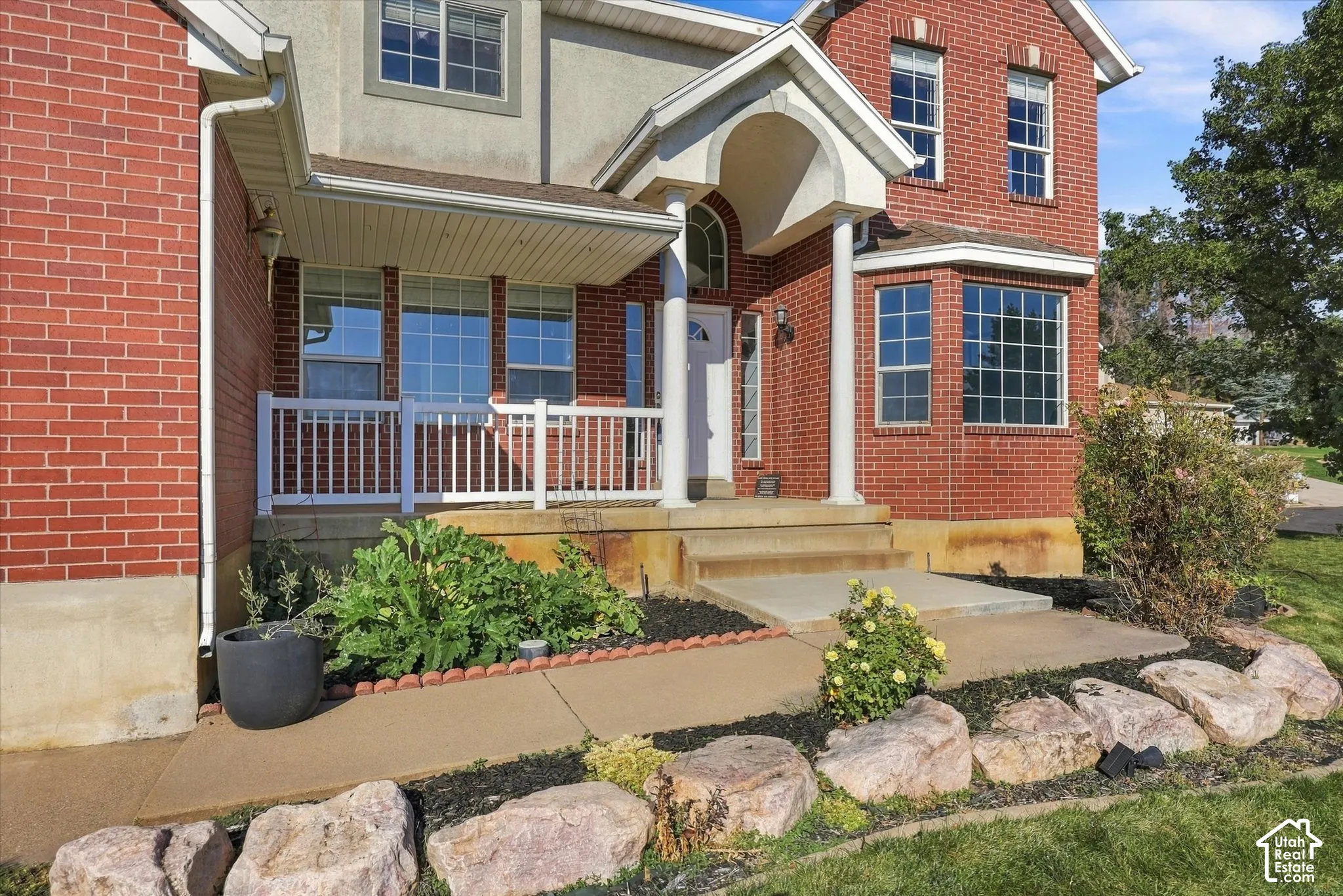 Front of house featuring lovely porch from which to sit and enjoy the incredible sunsets.