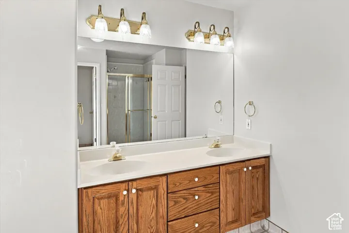 Dual vanity with integrated sinks, white countertop, and wood-finish cabinetry