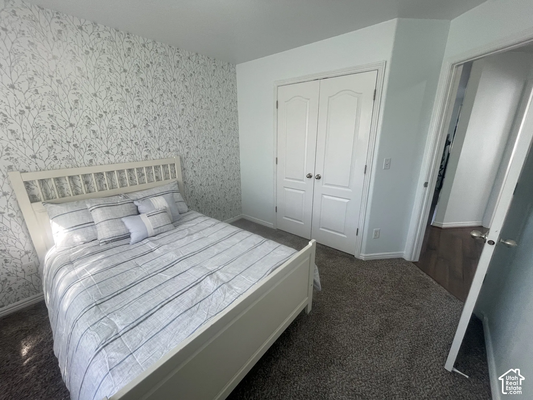 Accent wall with botanical-patterned wallpaper