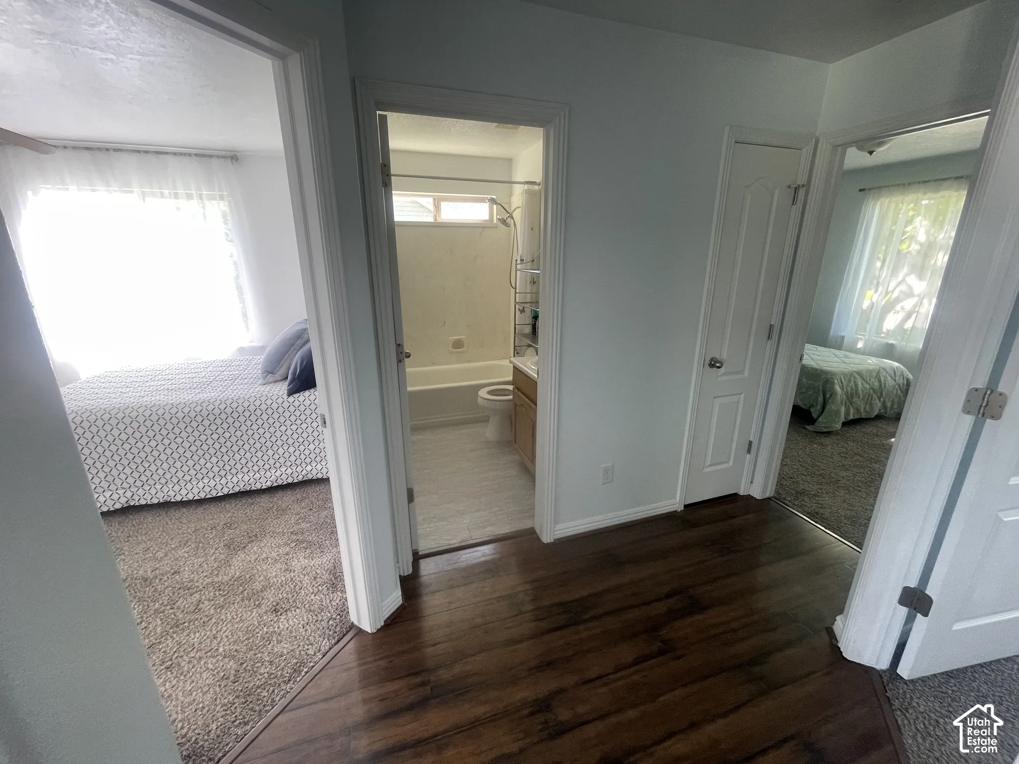 Wood-finish flooring throughout the hallway