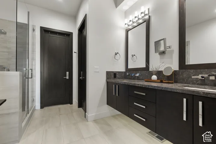 Floating double vanity with dark wood-finish cabinetry and light countertops