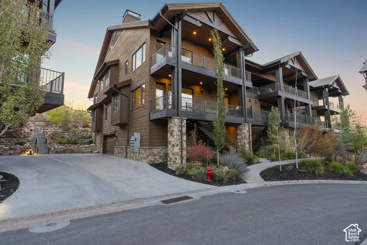 Multi-level exterior featuring wood siding and stone accents