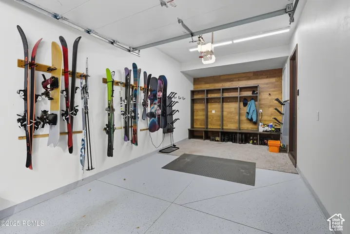 Garage with light-colored, speckled flooring