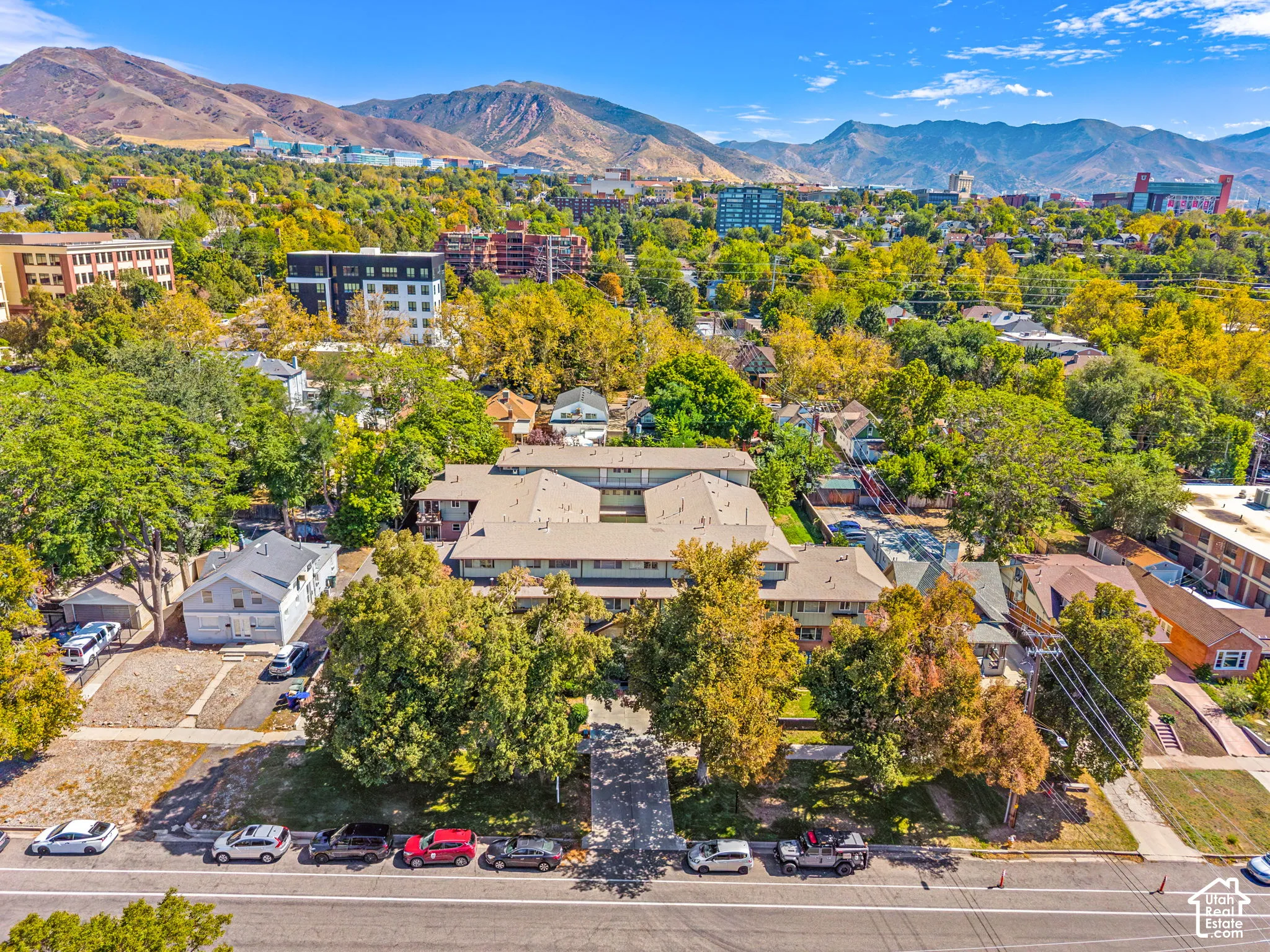 Multi-unit property featuring a flat roofline and a neutral-toned exterior