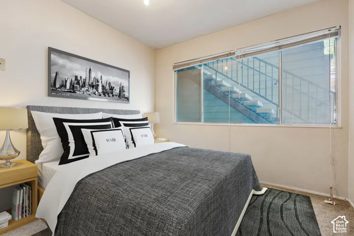 Carpeted flooring, window with blinds, and neutral wall tones