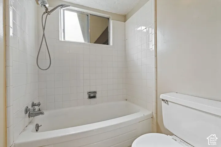 Tub and shower combination with white tile surround