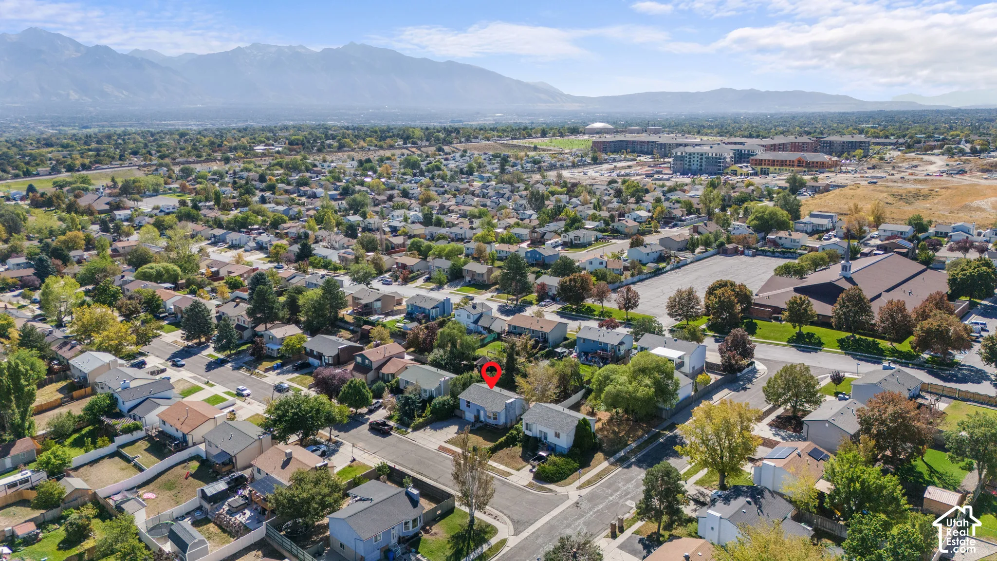 Aerial perspective of a residential neighborhood with a distant mountain backdrop