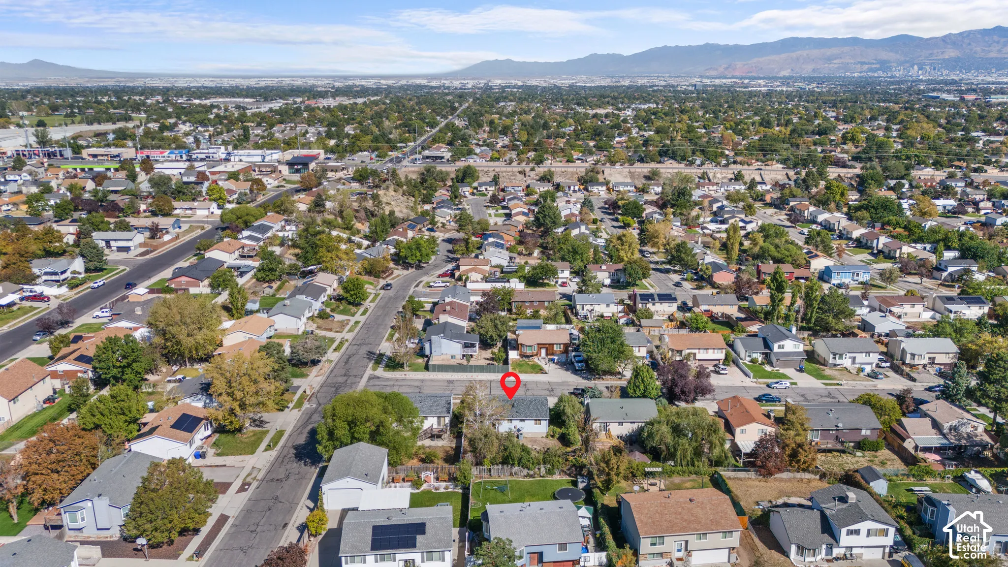 Residential area with mature trees and visible mountain range