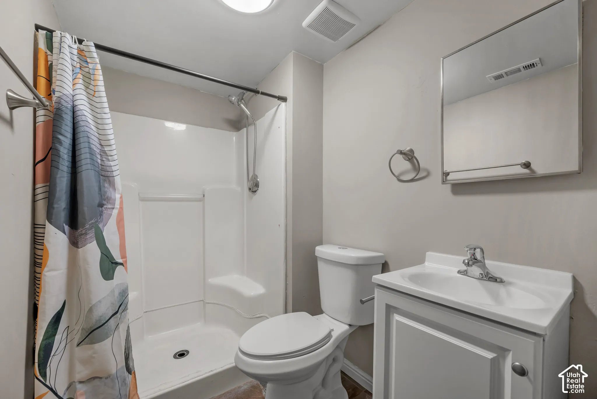 White single vanity with integrated sink, chrome faucet, and mirrored medicine cabinet