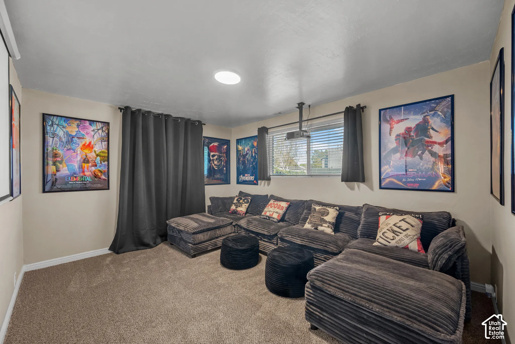 Media room featuring recessed lighting, a ceiling-mounted projector, and window with blinds