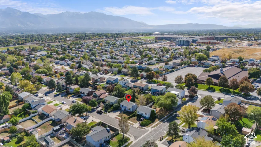 Aerial perspective of a residential neighborhood with a distant mountain backdrop