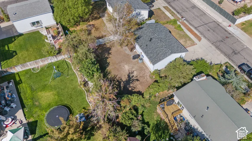 Residential property featuring a shingle roof and a paved driveway
