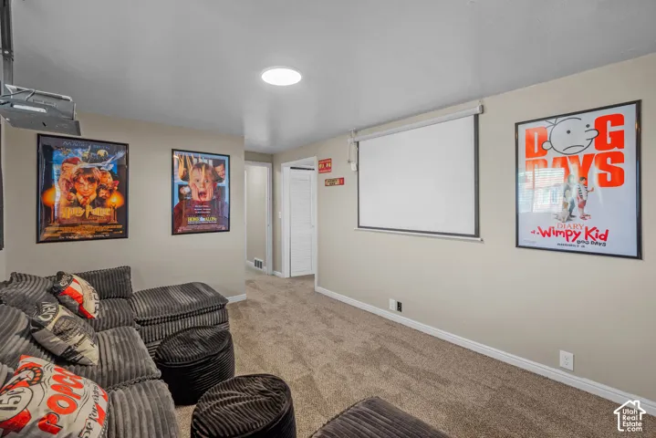 Dedicated media space featuring a drop-down projection screen and recessed ceiling lighting