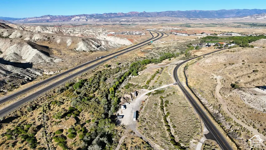 Expansive desert landscape featuring multiple roadways and distant mountains