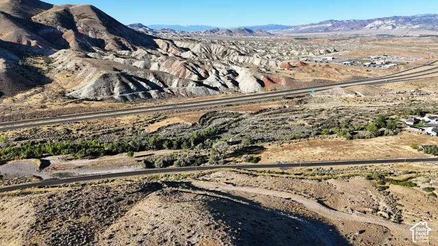 Expansive desert landscape featuring rugged terrain and distant mountain ranges