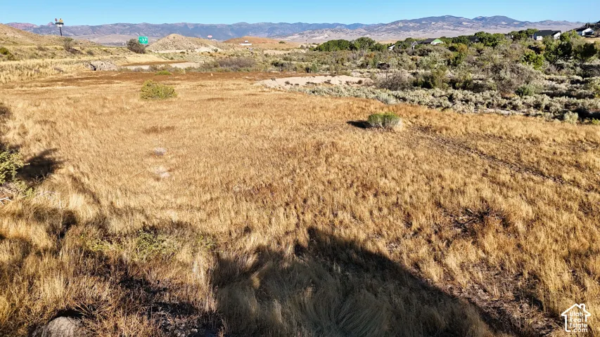 Expansive undeveloped land featuring natural vegetation and distant hills