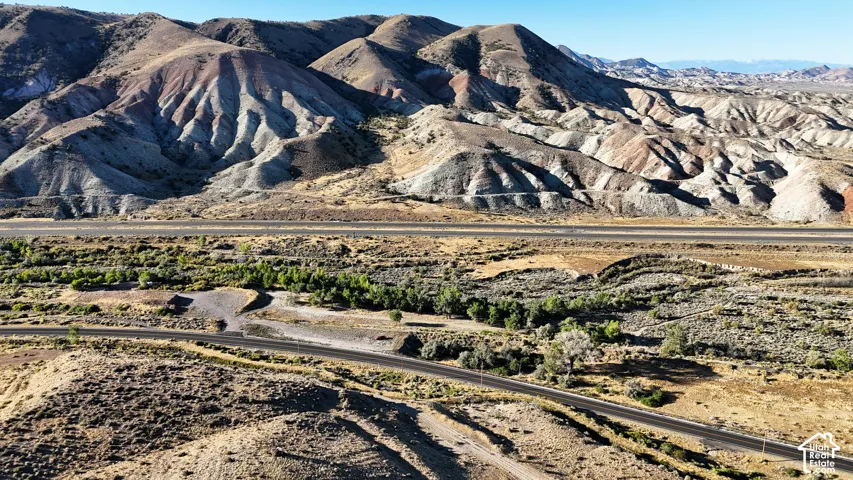 Expansive mountainous terrain with multiple roads and natural vegetation