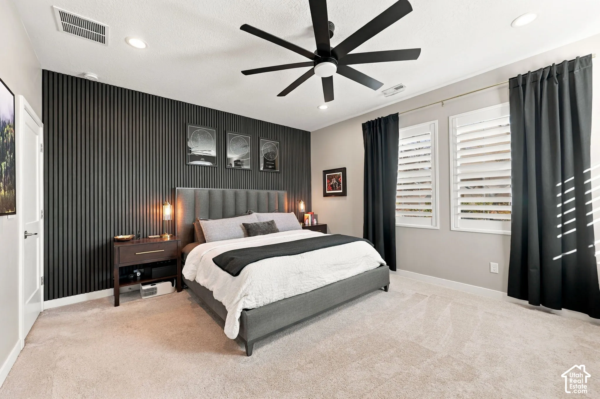 Accent wall featuring vertical paneling, recessed lighting, and a ceiling fan