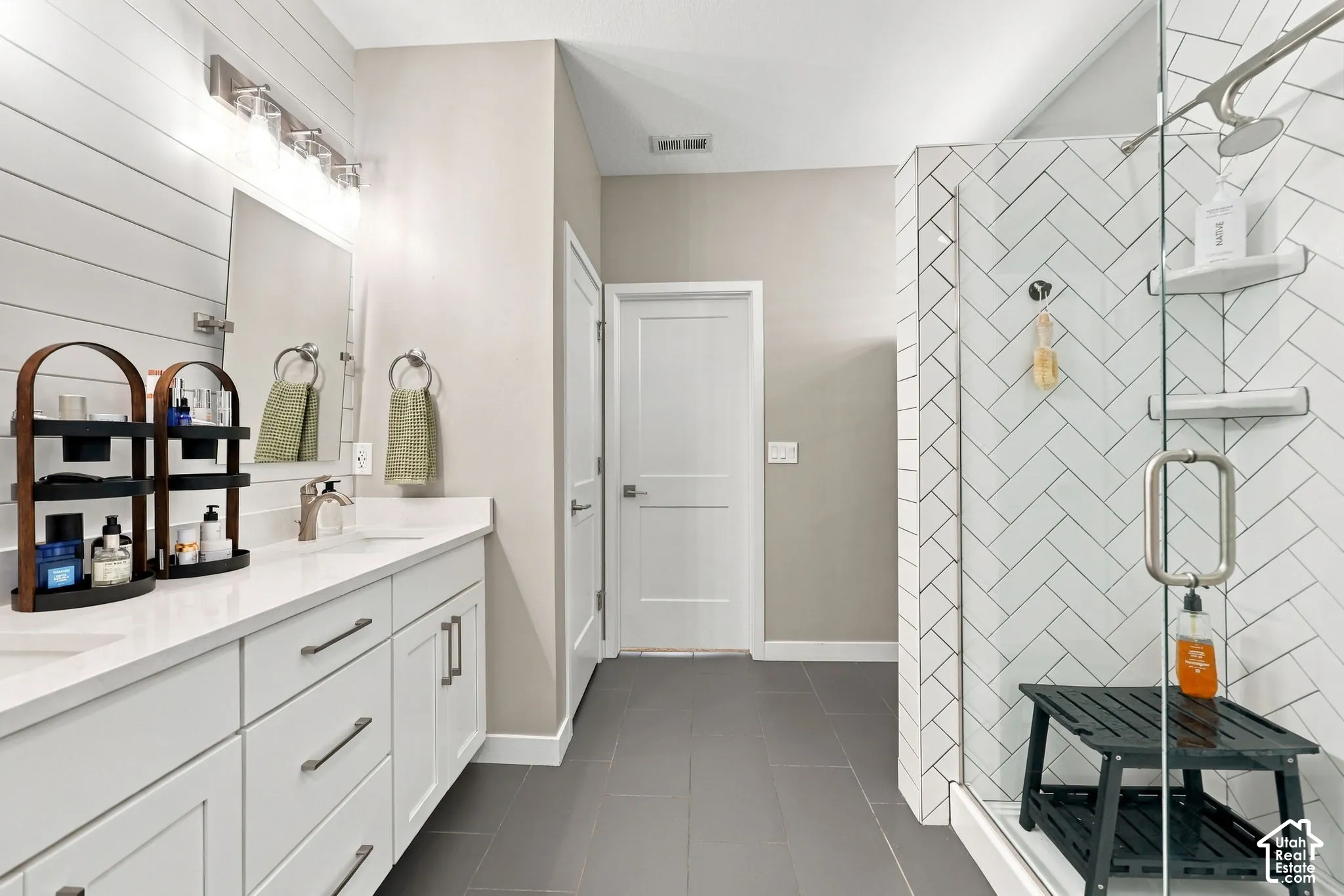 Dual vanity with white cabinetry and integrated sinks