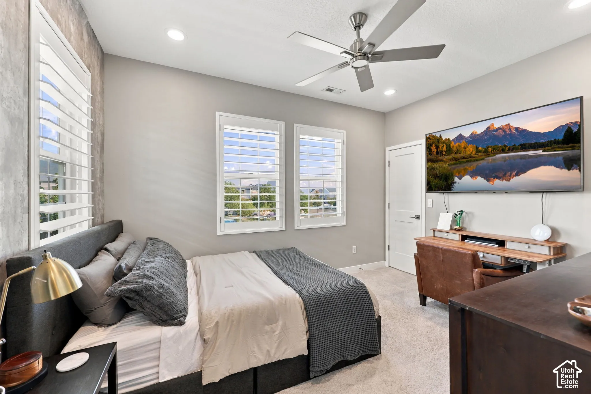 White plantation shutters, recessed lighting, ceiling fan with brushed nickel finish, neutral wall colors, and light-toned carpeting