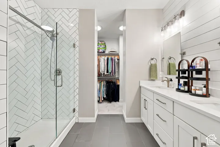 Herringbone tile shower with a frameless glass enclosure