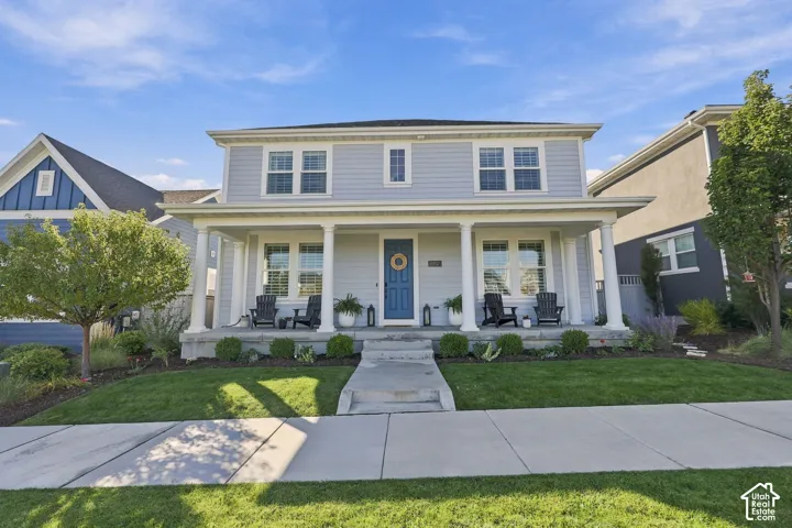 Two-story residence featuring light blue siding and white trim