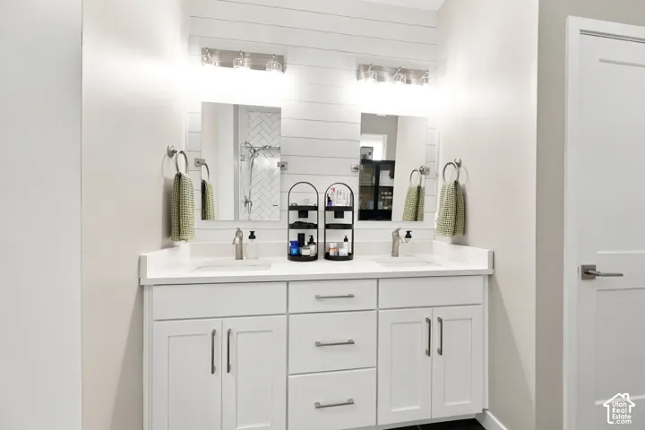 Dual vanity with shaker-style cabinetry, white countertops, and undermount sinks