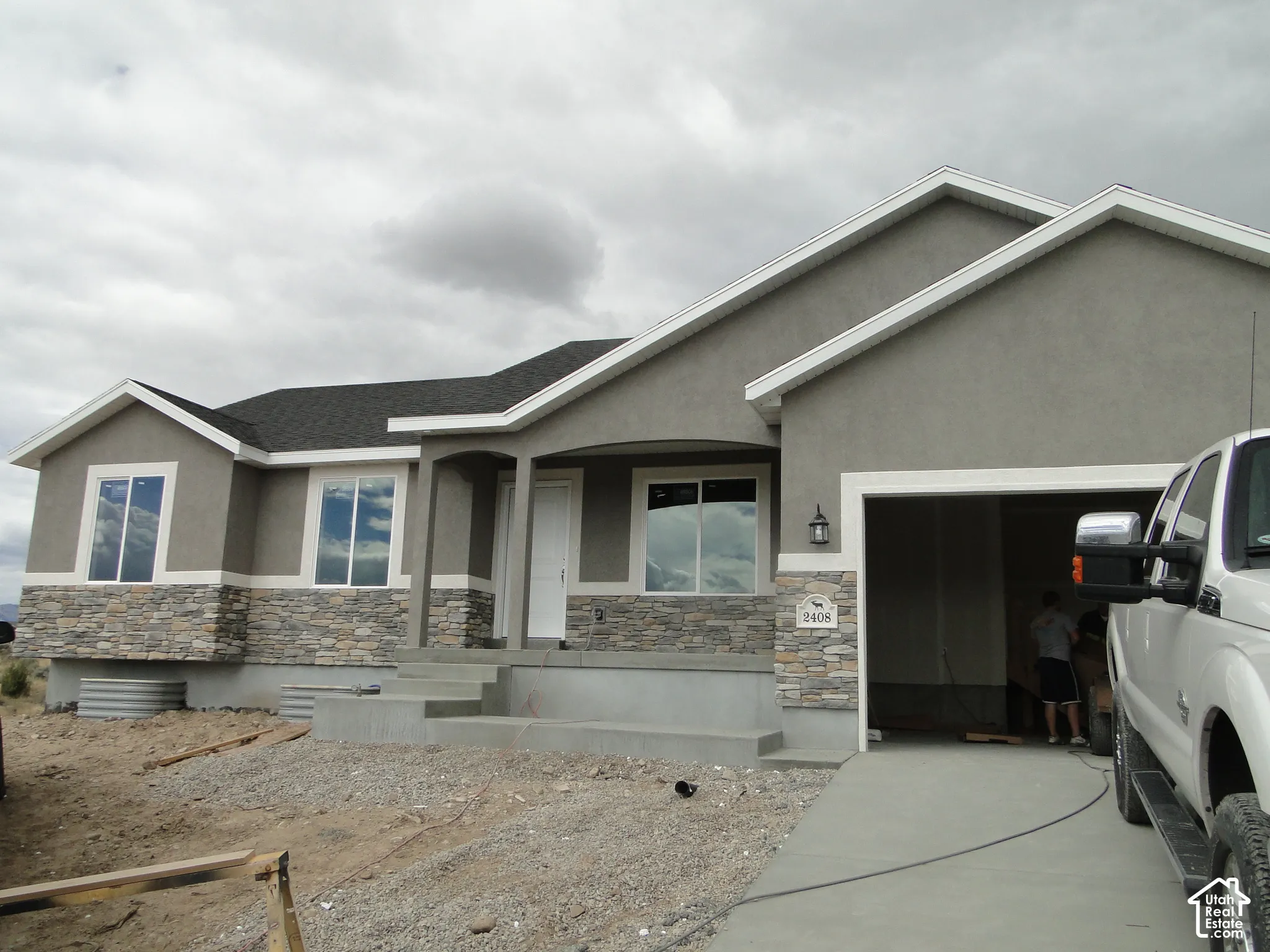 Single-story exterior with stucco siding and stone veneer accents