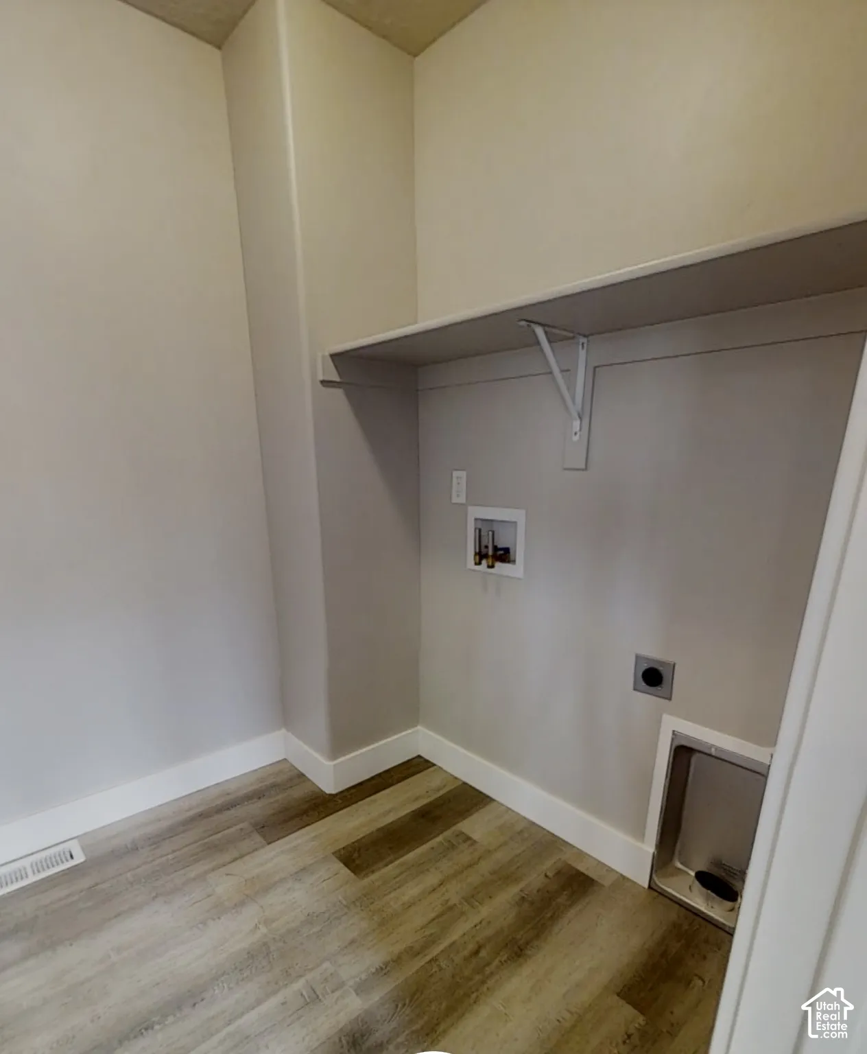 Wood-finish flooring, integrated utility connections, and an overhead shelf