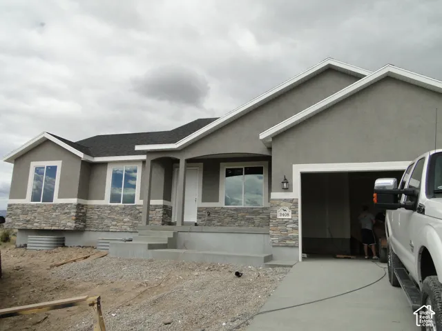 Single-story exterior with stucco siding and stone veneer accents