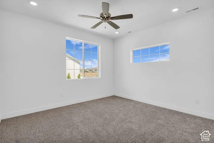 Primary bedroom with 9' ceiling and ceiling fan.