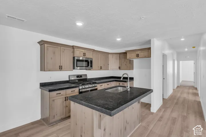 Terrific kitchen with stained wood cabinets, granite slab countertops, gas range, microwave, dishwasher and disposal.