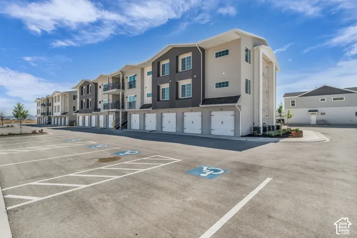 Rear of building with garage for each condominium and additional parking.