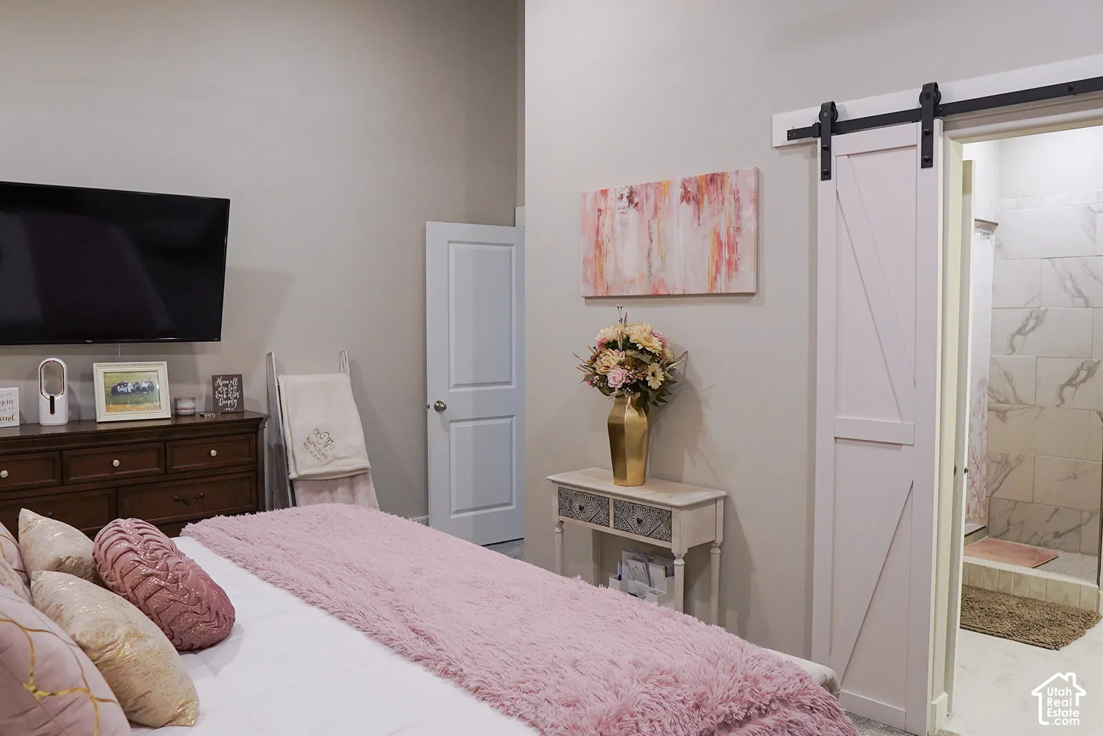 Barn door entry, light wall paint, high ceilings, recessed lighting, tile shower surround