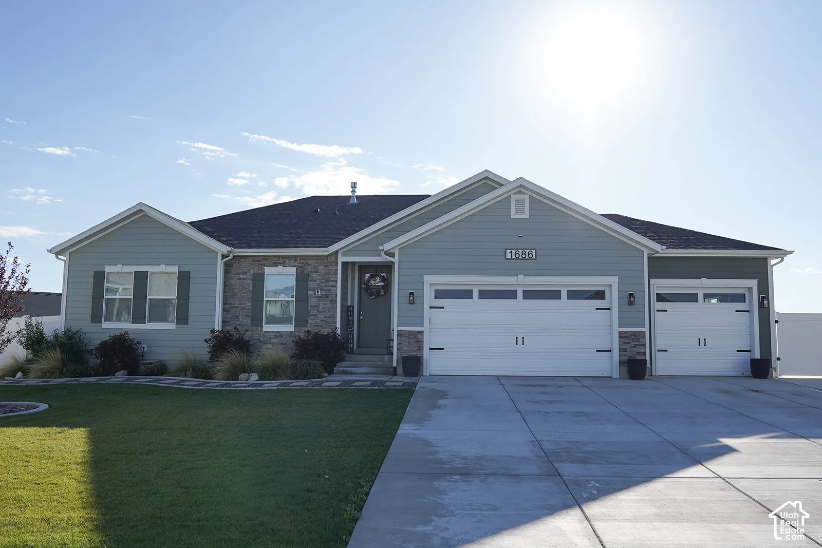 Ranch-style exterior with light blue siding and stone accents