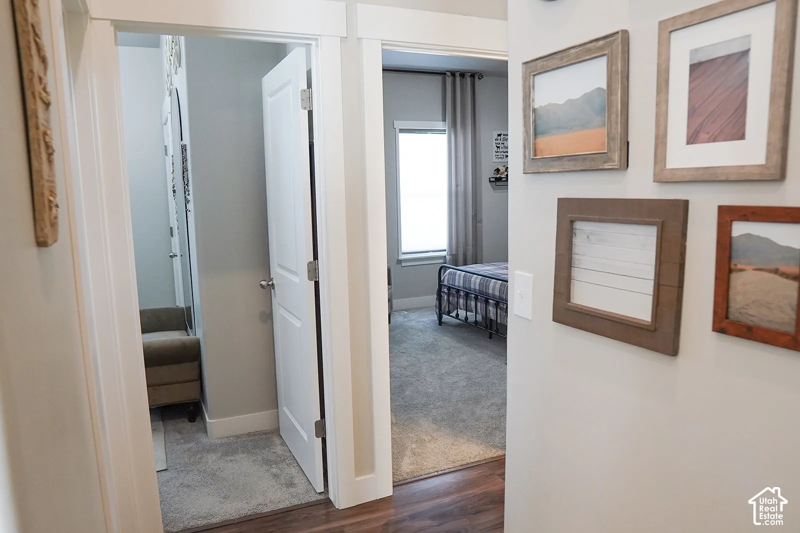 Carpeted room with a window featuring drapes, white trim, and a built-in shelf