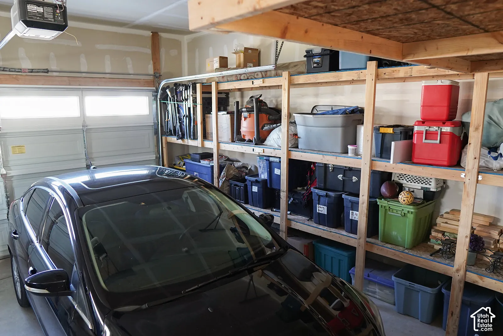 Garage with overhead storage and installed shelving