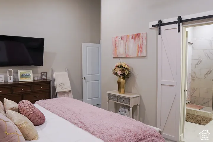 Barn door entry, light wall paint, high ceilings, recessed lighting, tile shower surround