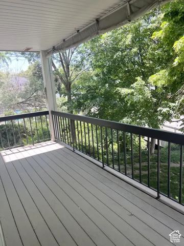 Outdoor deck featuring composite decking and black metal railings