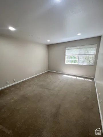Recessed lighting, wall-to-wall carpeting, and a window with blinds