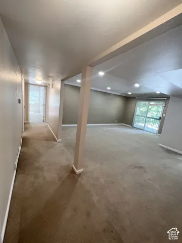 Spacious room with recessed lighting and neutral carpeting