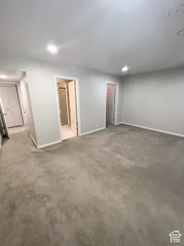 Recessed ceiling lighting, light neutral wall paint, and neutral carpeting