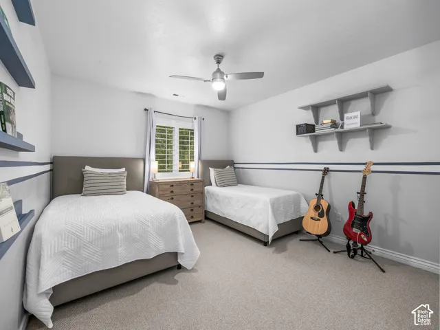 Recessed lighting, ceiling fan with light fixture, window with plantation shutters, wall-mounted shelving, and neutral wall tones