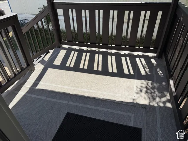 Porch with dark-toned railings and a patterned privacy screen