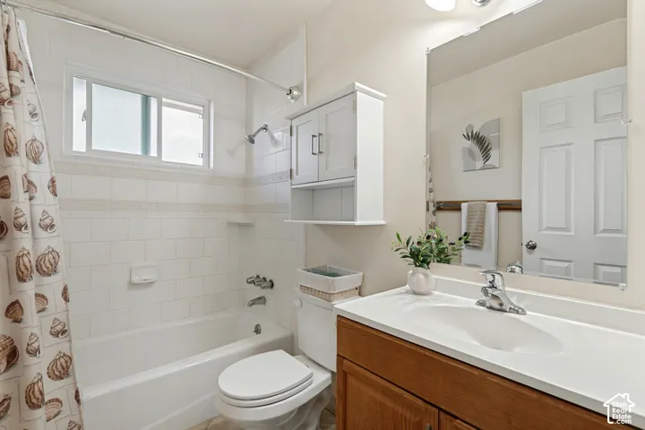 Main level Bathroom with white tile shower surround with a built-in tub.